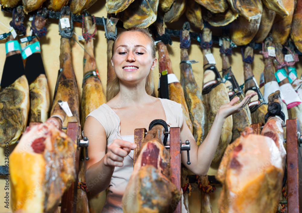 woman buying dried ham