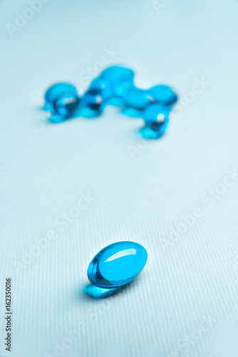 Blue and white vitamin capsules