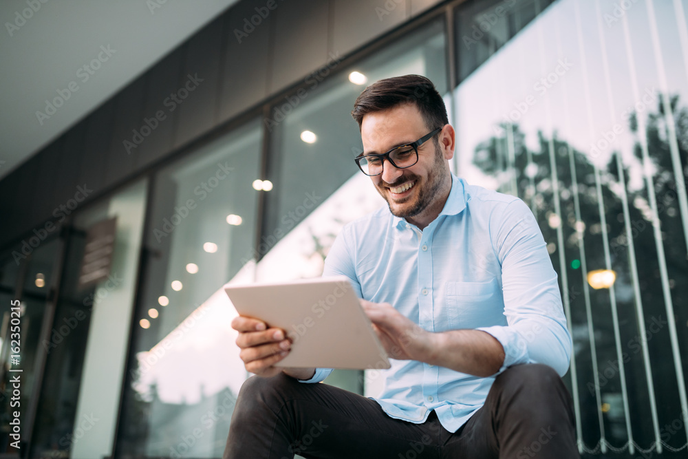 Portrait of businessman in glasses holding tablet Portrait of businessman in glasses holding tablet