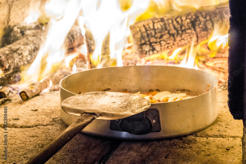 Delicious pizza in oven with firewood Delicious pizza in oven with firewood