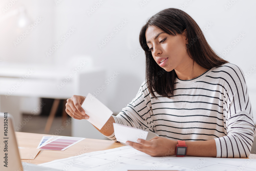 Pleasant attractive woman sitting at the table Pleasant attractive woman sitting at the table