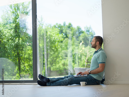 man drinking coffee on the floor enjoying relaxing lifestyle