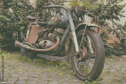 Old motorcycle in the courtyard of the house