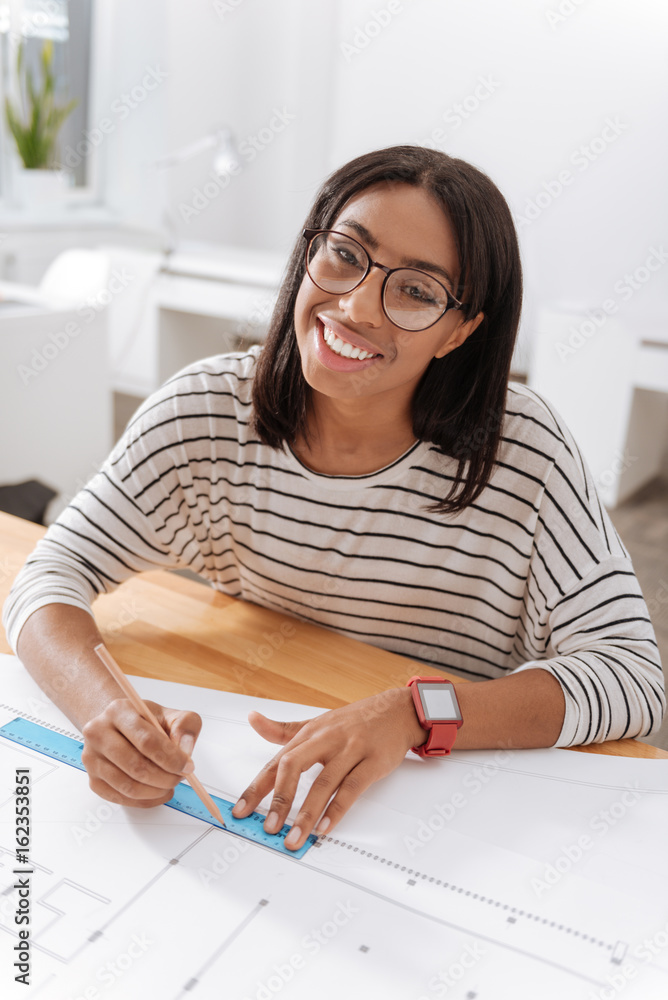 Positive nice woman being happy about her job