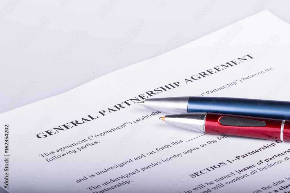Blank Partnership contract with two pens on top of the first page Blank Partnership contract with two pens on top of the first page