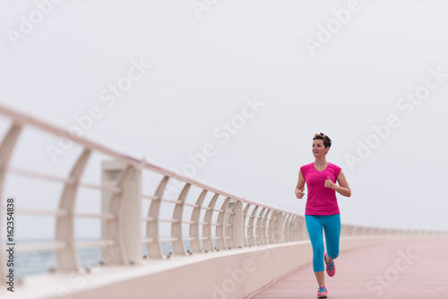 woman busy running on the promenade