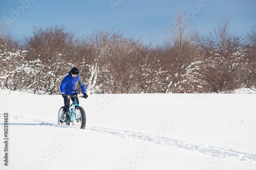 Man riding his fat bike in the snow