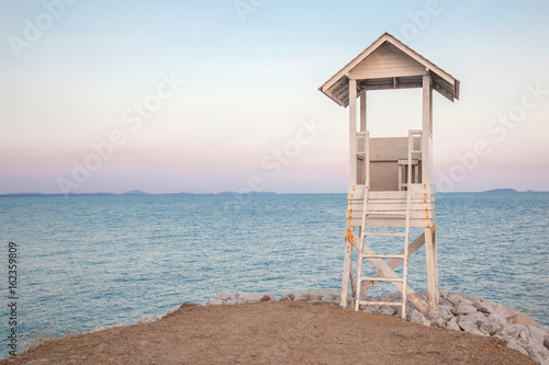 lifeguard stand beside the beach in the evening scene © alittledit