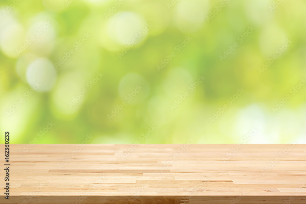 Wood table top on bokeh abstract green background Wood table top on bokeh abstract green background
