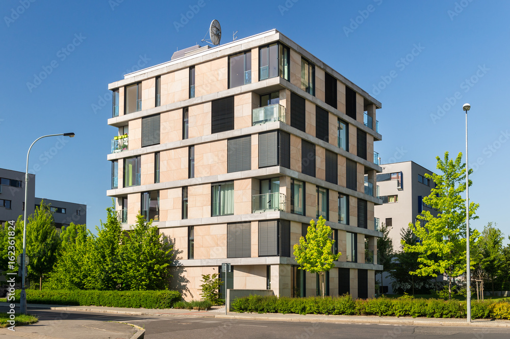 Obraz premium Street with modern block of flats, photo with blue sky
