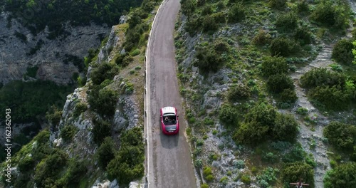 red sport convertible car moving in Amalfi coast