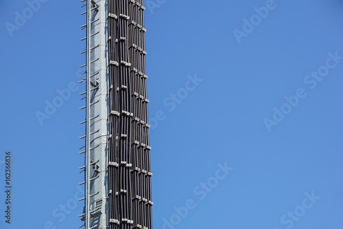 Industrial tower and stairs against the blue sky.