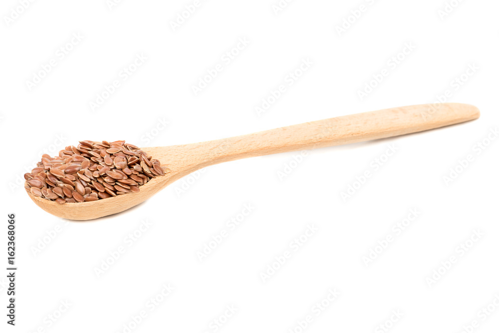 Flax seeds in wooden spoon isolated on white background Flax seeds in wooden spoon isolated on white background
