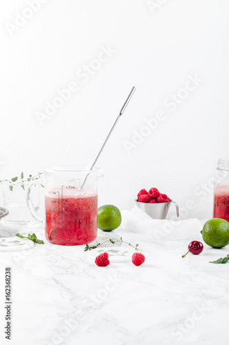 Wallpaper Mural Pitcher with refreshing watermelon and strawberry lemonade with lime juice, ginger and honey on marble table and white background. Summertime beverage concept. Copy space Torontodigital.ca