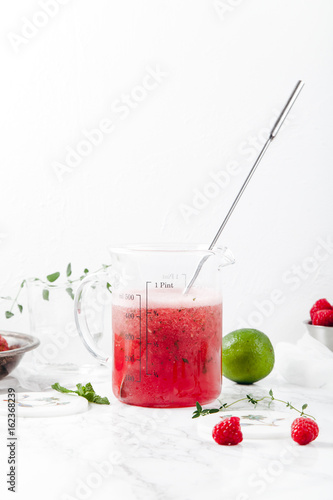 Wallpaper Mural Pitcher with refreshing watermelon and strawberry lemonade with lime juice, ginger and honey on marble table and white background. Summertime beverage concept. Copy space Torontodigital.ca