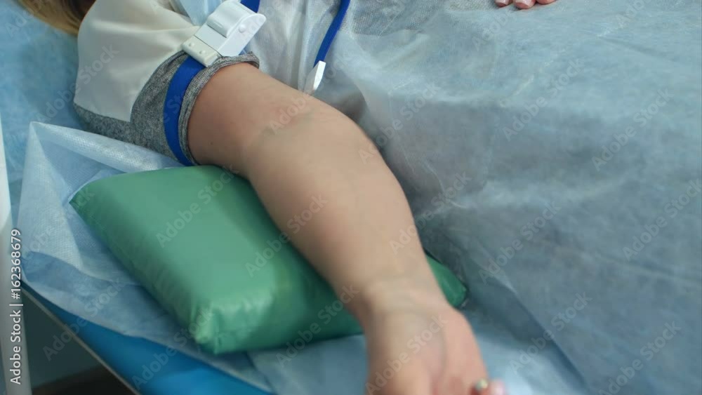 Nurse putting intravenous injection on patient arm for drip medicine Nurse putting intravenous injection on patient arm for drip medicine
