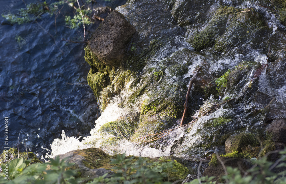 small waterfall with a view from above small waterfall with a view from above