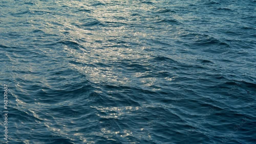 Fly over ocean water surface in evening time Fly over ocean water surface in evening time