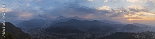 Panoramic view of snow-covered Himalaya peaks of a mountain ridge Annapurna  at sunrise  under the first beams of the sun. 
