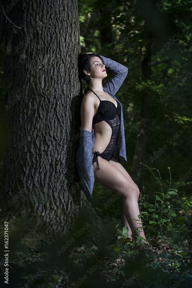 Pretty young girl posing outdoor in a forest