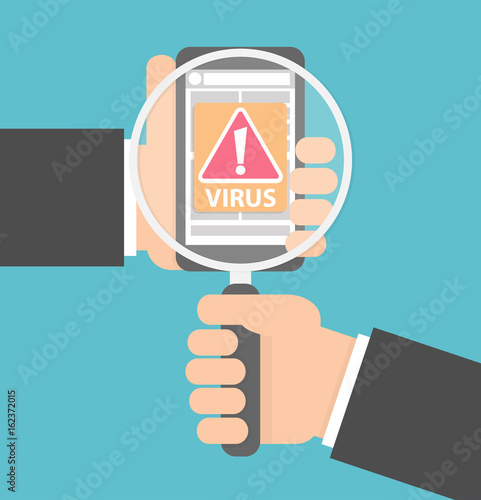 Virus check on mobile phone concept. Hand holding a magnifying glass over a smartphone