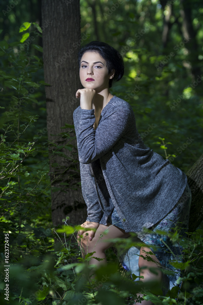 Pretty young girl posing outdoor in a forest Pretty young girl posing outdoor in a forest