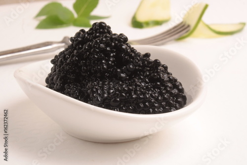 Black caviar on white background