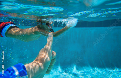 love sport - thumb up and little boy swim underwater