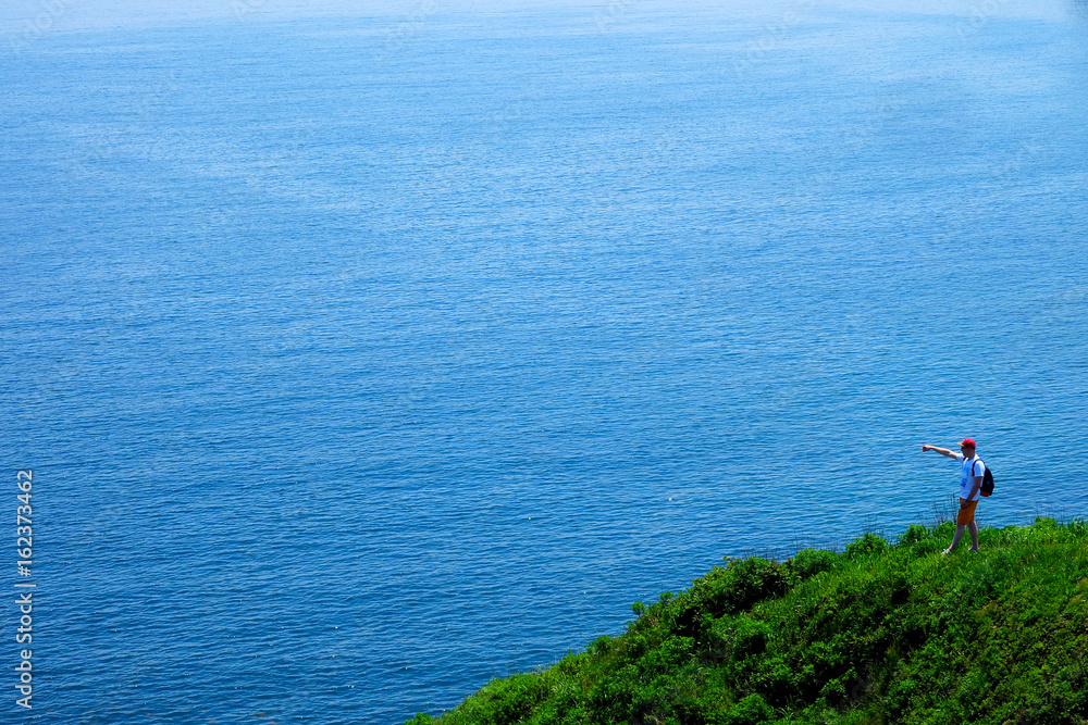 Traveler man looking at beautiful seascape. Summer seascape Russian Island, Vladivostok, Primorye Territory June, 2017