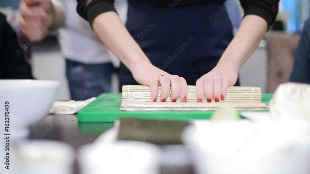 Woman Chef Filling Japanese Sushi Rolls Woman Chef Filling Japanese Sushi Rolls