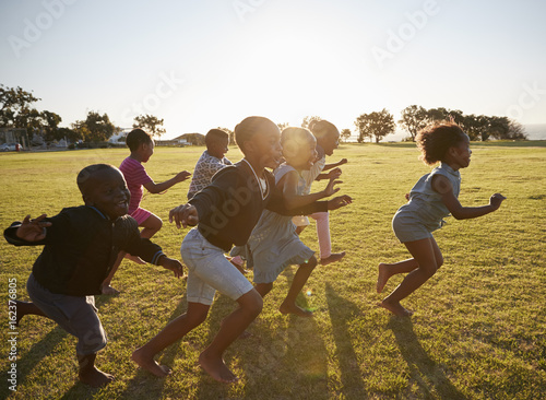 Elementary school kids running together in an open field