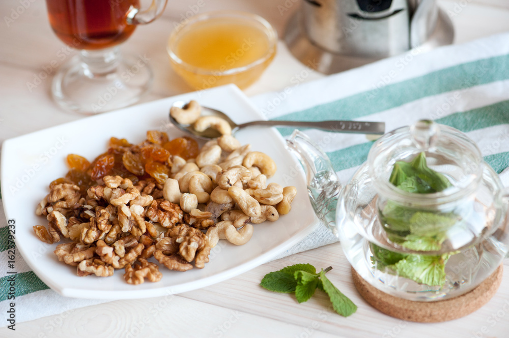 Healthy breakfast: nuts mix and mint tea