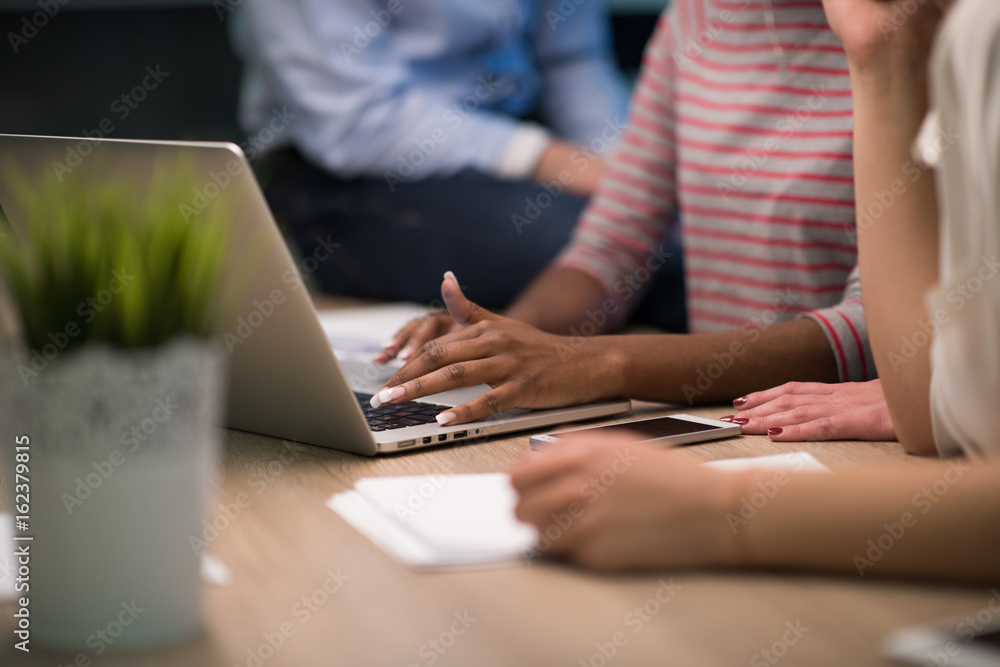 Multiethnic startup business team in night office Multiethnic startup business team in night office