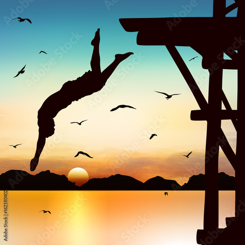 Silhouette and jumping man in the twilight with blue sky.