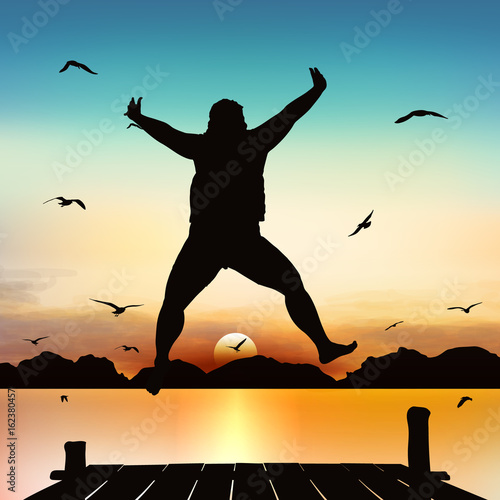 Silhouette and jumping girl in the twilight with blue sky.