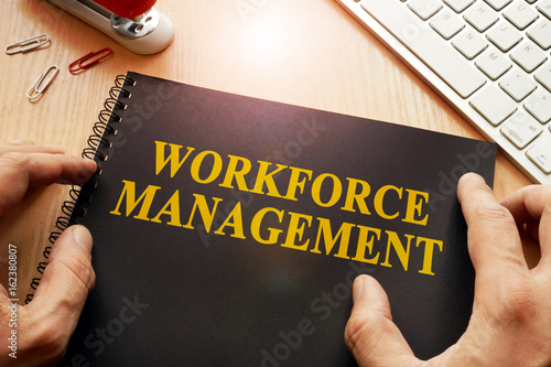 Book with name workforce management in an office. photo