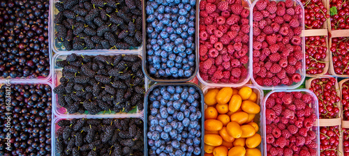 Baskets of berries in a market. mixed berries. bio colorful berries
