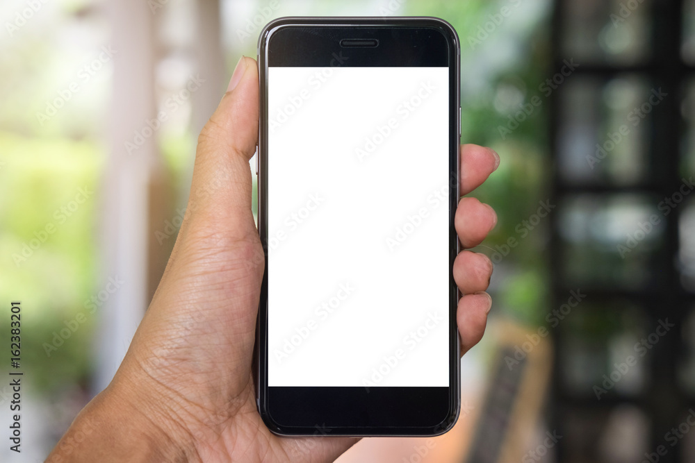 Close up of a man hand holding smart phone with blank screen mobile in coffee shop.