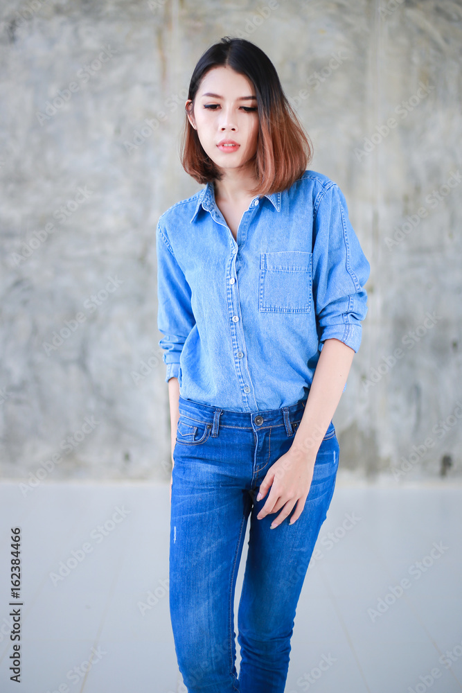 Asian woman casual outfits standing in jeans and blue denim shirt, women  brown hair and short hair, beauty and fashion jeans concept Photos | Adobe  Stock