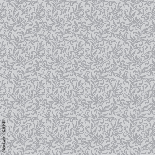 Elegant seamless pattern. Tracery of swirls and decorative leaves on a gray background. Vintage style. It can be used for printing on fabric, wallpaper, wrapping