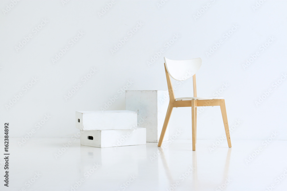 Fototapeta premium Wood chair on white background with white wood boxes and soft reflection on the floor