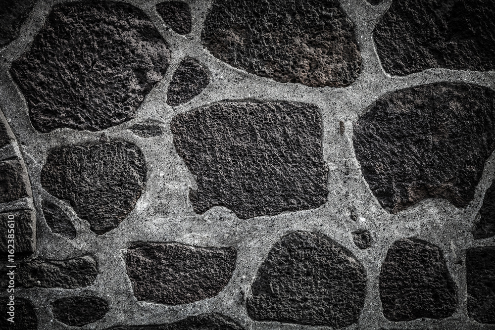 Fototapeta premium Texture of natural stones on the wall of traditional Iceland house for background. Toned
