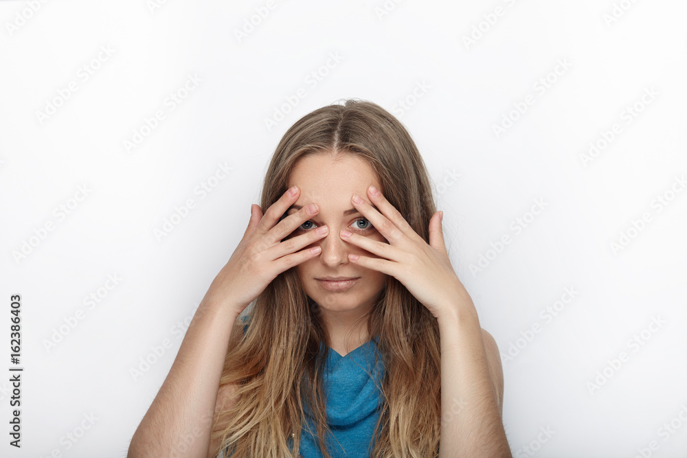 Headshot of young adorable blonde woman with cute smile on white background Headshot of young adorable blonde woman with cute smile on white background