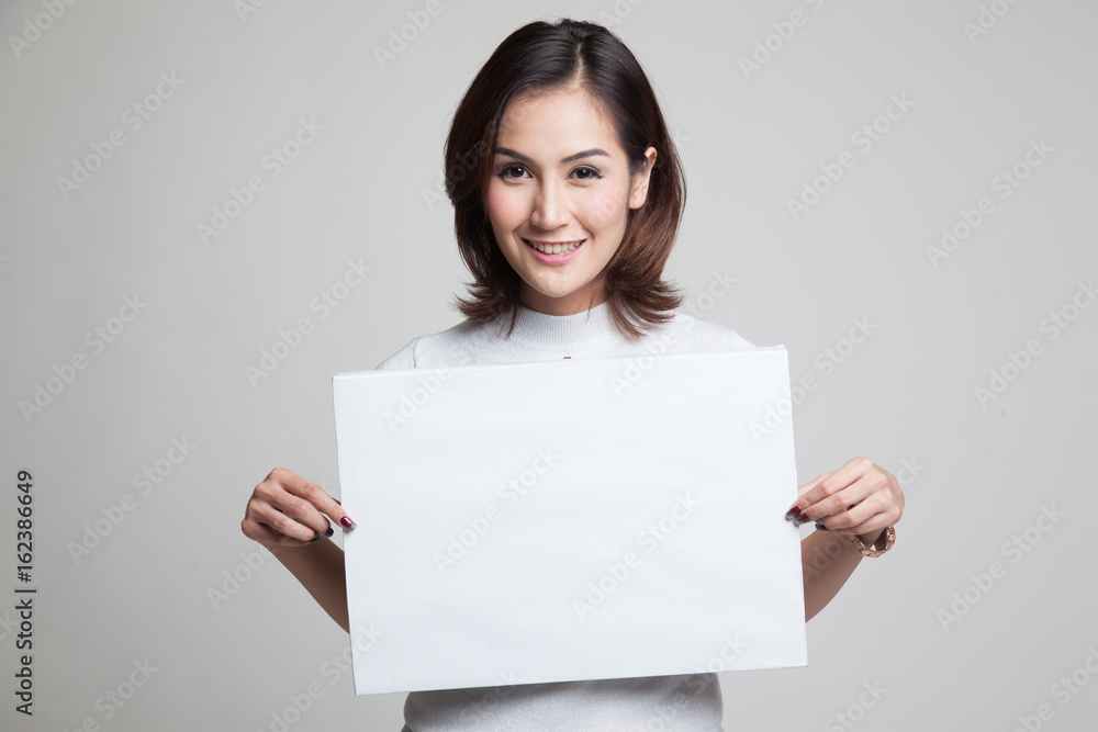 Young Asian woman with white blank sign. Young Asian woman with white blank sign.