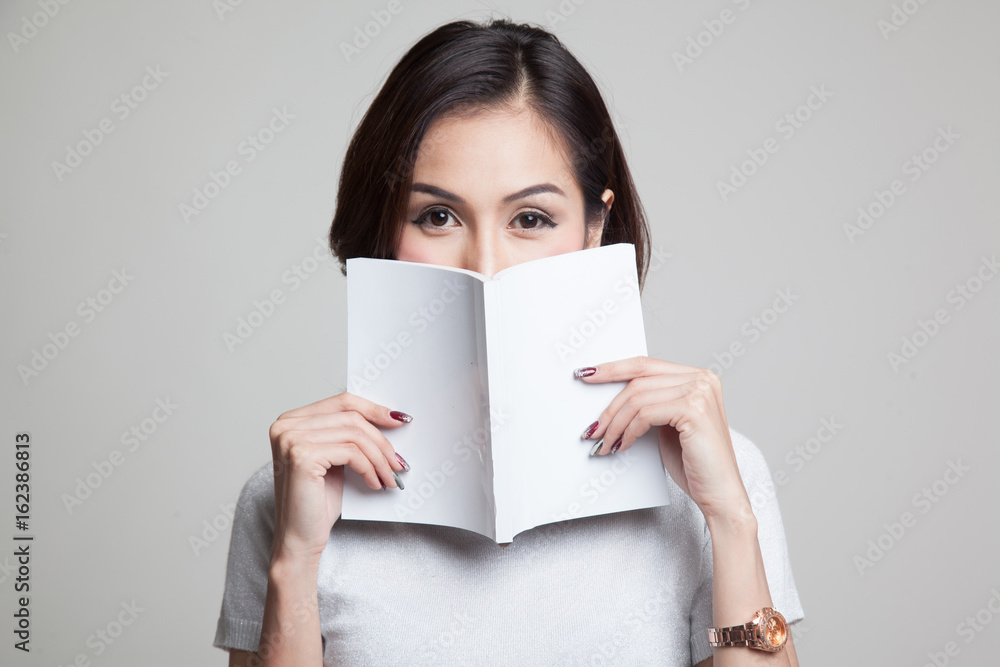 Young Asian woman with a book. Young Asian woman with a book.