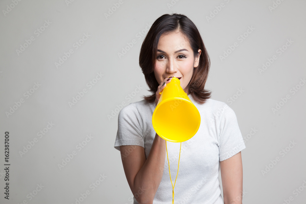 Beautiful young Asian woman announce with megaphone. Beautiful young Asian woman announce with megaphone.