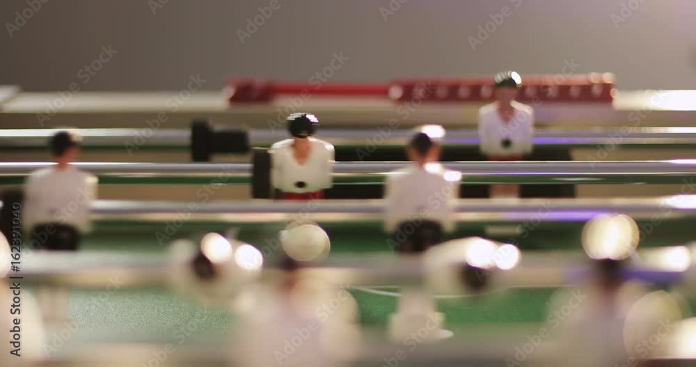 A man's hand changes the score on the table football. A man's hand changes the score on the table football.