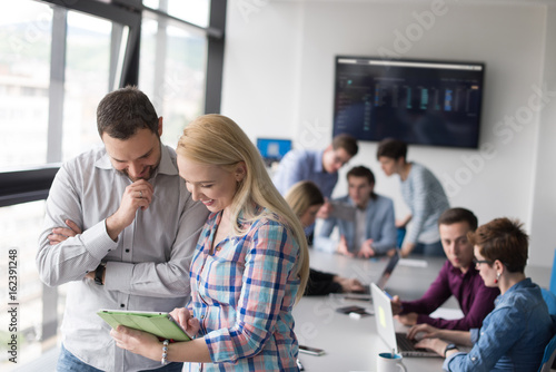 Two Business People Working With Tablet in office