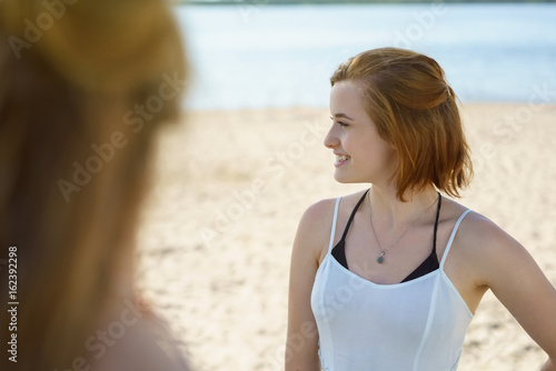 young woman on the beach with a friend