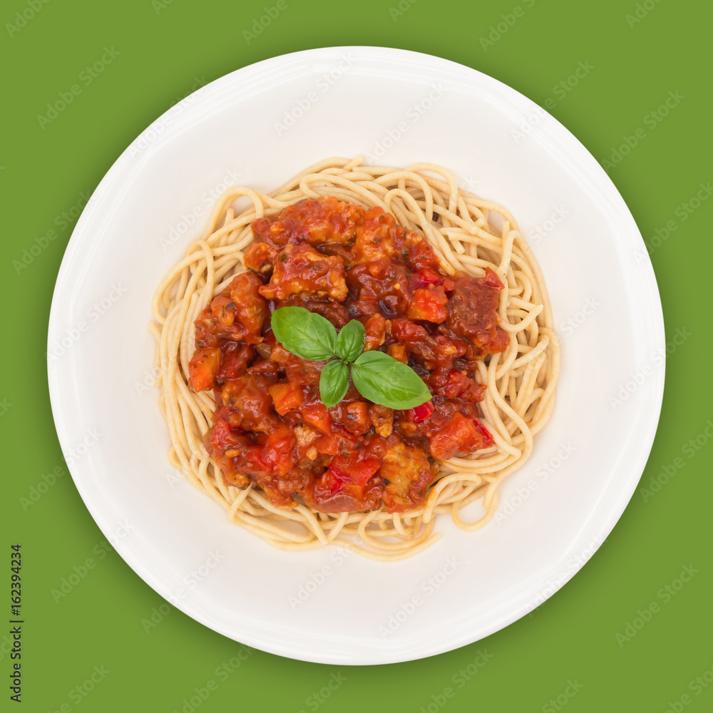 © Creatus - Spaghetti Bolognese on white plate isolated on green background, overhead view